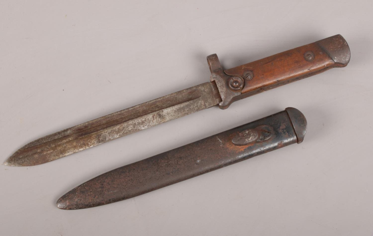 A WWI short bayonet with metal scabbard.