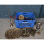 A box of metalwares. Including brass wall plaques, trophies, horse brasses, etc.
