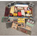 A box of miscellaneous. Includes vintage tins, puppets, cutlery etc.