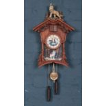 A Chalet style composite and wood Cuckoo clock. Decorated with wolfs by The Bradford Exchange.