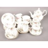 A Twenty-Two Piece Royal Albert Tea Service in the 'Moss Rose' Pattern. To include Teapot, Teacups