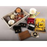 A box of collectables. Includes AA badge and member's handbook, cufflinks, Crown Devon Fieldings