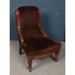 A Victorian mahogany upholstered nursing chair.