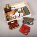 A box of collectables. Includes Bryant & May matchbox holder, vintage cased spectacles, military