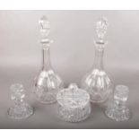 A small collection of crystal glassware. Includes decanters, candlesticks and a lidded pot.