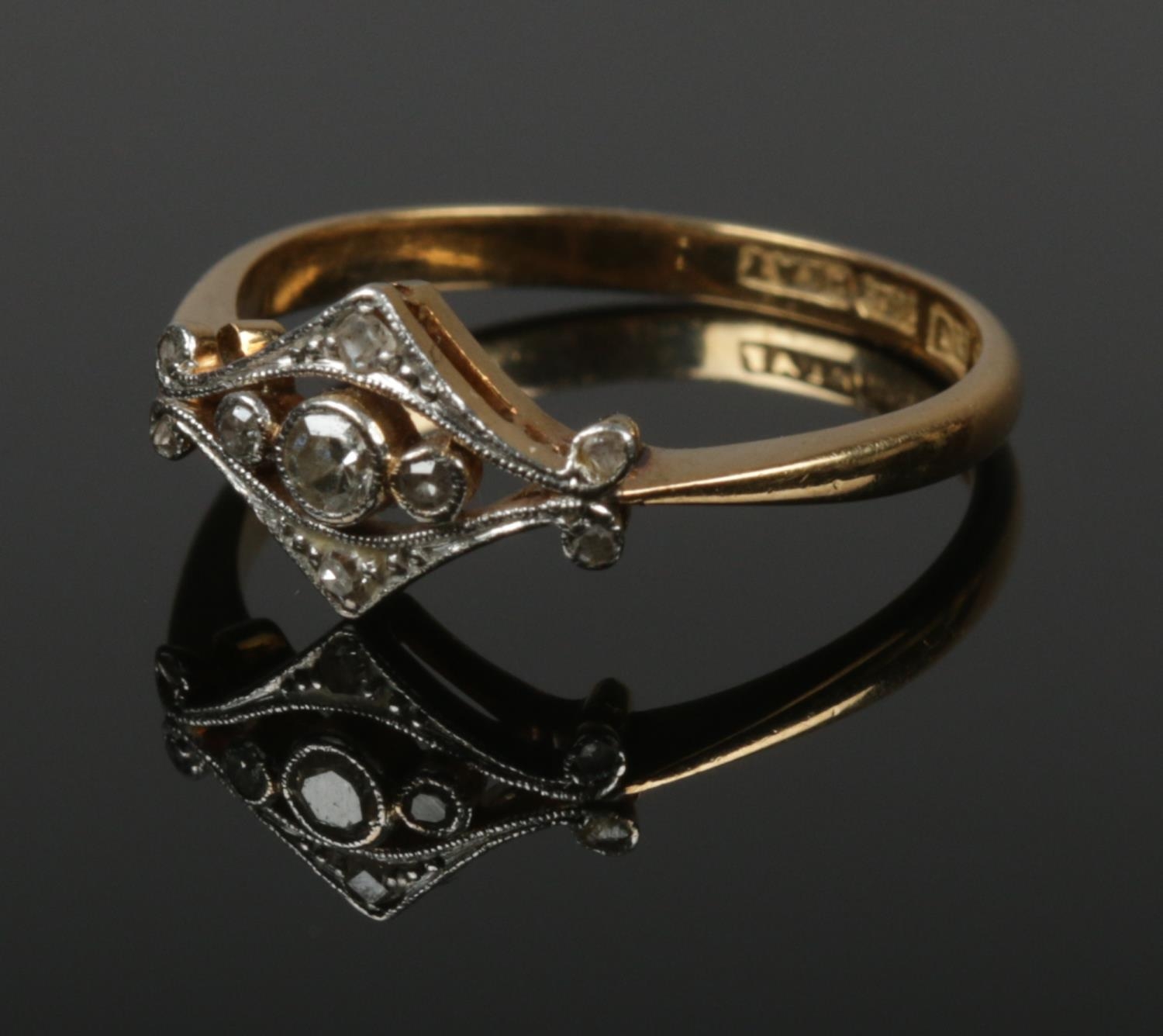 An 18ct gold and platinum diamond ring. Size L. 2.02g.