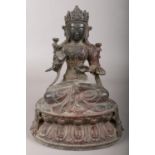 A Chinese bronze devotional figure raised on lotus plinth. 23cm.