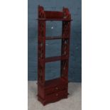 A small hard wood open bookcase with drawer base.
