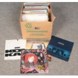 A box of LP records and 12 inch singles, mixed genres.