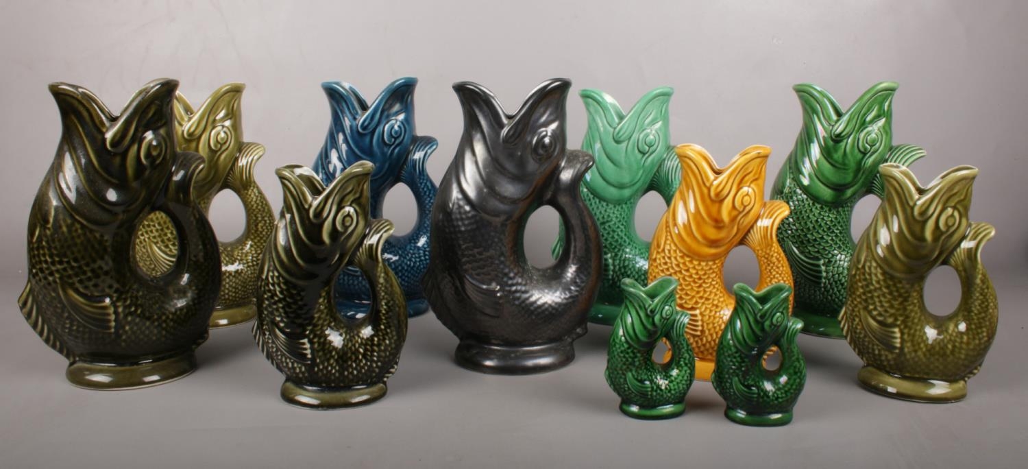 A group of Dartmouth Devon glazed gurgling fish jugs. Various colours and sizes.