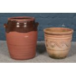 Two terracotta planters. One part glazed and double handled. Largest: H: 35cm W:25cm.