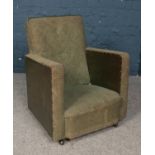 A vintage child's upholstered arm chair.