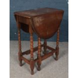 A small oak drop leaf table. With bobbin turned supports.