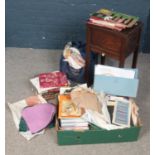 An oak sewing box along with a box and two bags of associated books, patterns, fabrics etc. Books
