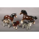 Five ceramic figures of horses.