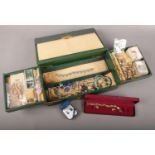 A jewellery box with contents of costume jewellery. Includes marcasite fox brooch, simulated pearls,