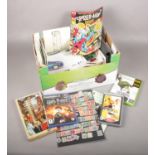 A box of miscellaneous. Includes stamps, games, football programmes etc.
