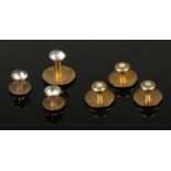 A collection of gold dress studs. Includes three 15ct gold pearl set examples and three 9ct gold