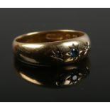 An 18ct gold diamond and sapphire ring. Size N. 2.29g.