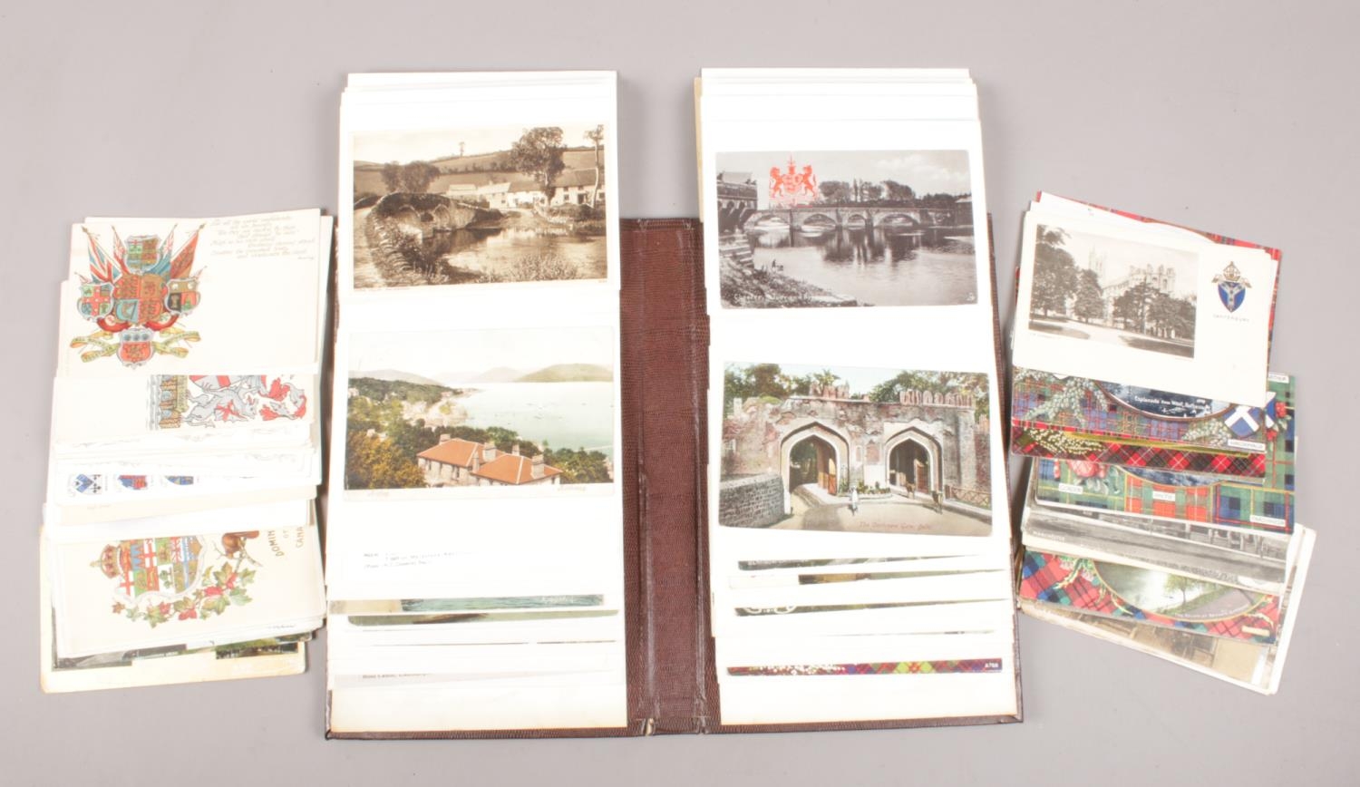 A collection of vintage postcards, loose and in album. Over 100.