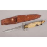 A William Rodgers knife with hoof handle and leather sheath.