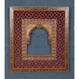 An ornate Eastern frame with painted floral decoration. 55cm x 50.5cm.