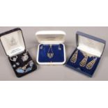Three cased silver jewellery sets. Includes marcasite, tricolour and doublet examples.