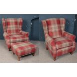 A pair of his and hers wing back arm chairs and matching footstool.