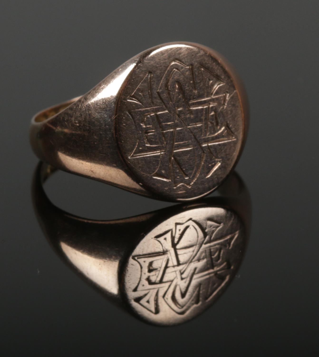 A 9ct gold signet ring with monogrammed panel. Size P. 4.86g. Looks to have been resized.