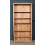 A large light oak open bookcase.