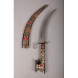 An eastern curved dagger in wooden sheaf. Decorated with with scrolls of white metal and painted red