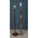 An Indian brass standard lamp, along with a turner mahogany example.
