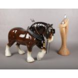A large ceramic shire horse (26cm h) & a composite couple cuddling figure (32cm h).