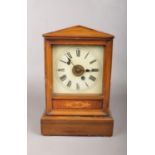 A oak cased striking mantel clock with pendulum. (has key) 27cm h 18cm w 12.5 cm d