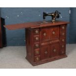 A walnut cased Singer treadle sewing machine.