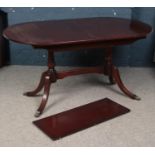 A Strongbow Extendable Mahogany Dining Table with Chairs.