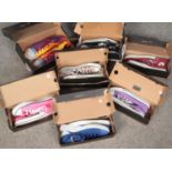 Seven boxed pairs of Converse. Mostly men's size 11s/women's 13s.