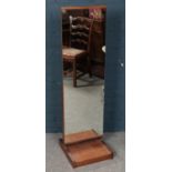 A teak cheval mirror.