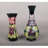 Two Moorcroft 'Violet' vases by Sally Tuffin. marks to base. 17cm height 13 cm height.