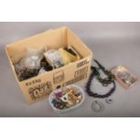 A box of costume jewellery. Beads, bracelets, earrimga etc.