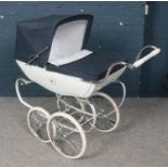 A Silver Cross pram with navy blue hood.