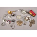 A collection of white metal collectables and oddments. Includes reproduction Thaler, charms,