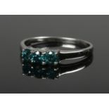 A 9ct white gold and three stone blue diamond ring. (.75ct of diamonds). Size Q. 2.3g.