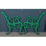 A pair of painted cast iron lion mask bench ends.