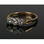 An 18ct gold three stone diamond ring. Size N 1/2. 2.73g.