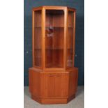 A teak glazed corner cupboard.