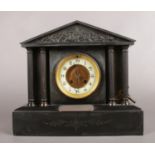 A Black Slate Mantle Clock with Metal Columns depicting a classical battle scene. Silver