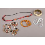 A collection of jewellery. Includes mixed stones necklace, amber, bone bangle etc.