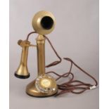 A stick brass telephone. Comprising of a ring dial to the circular base and etched to the front G