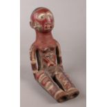 An unusual African pottery seated figure.